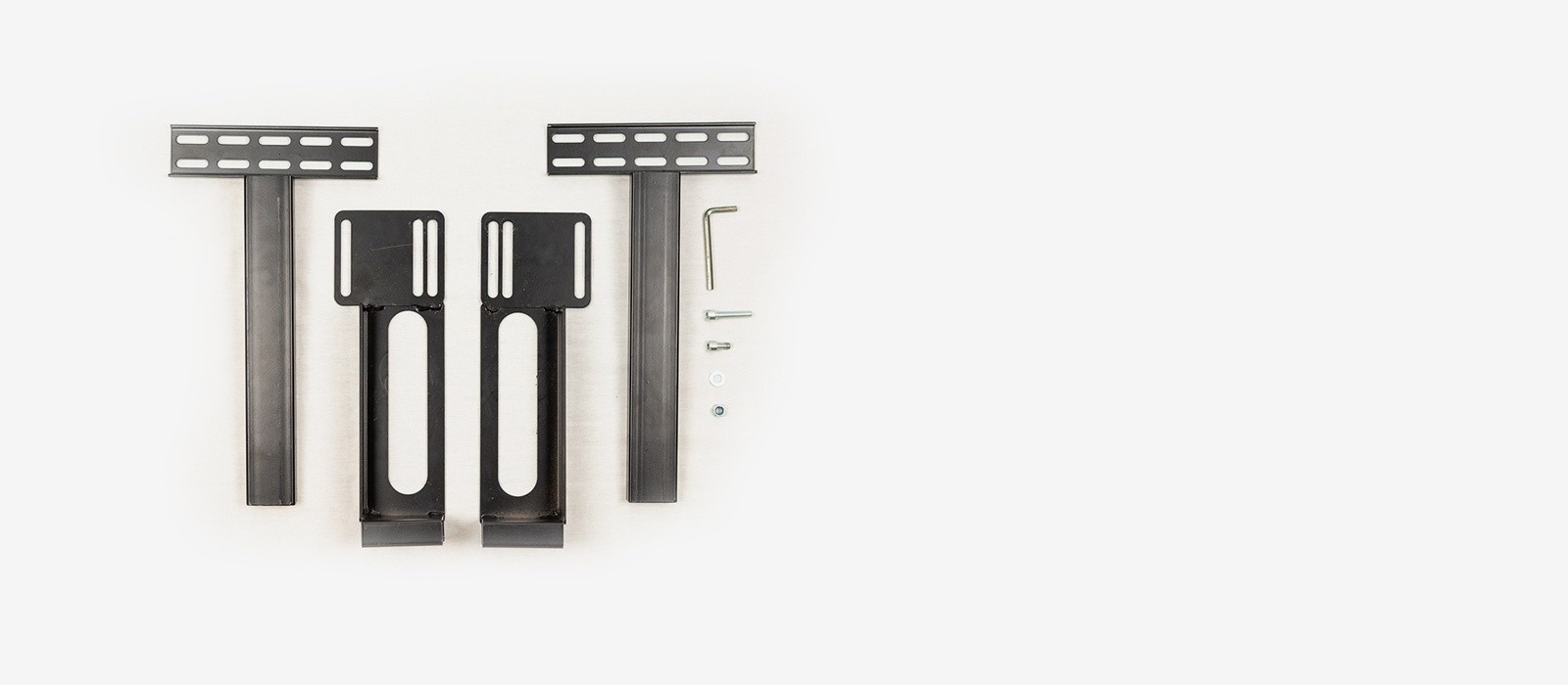 The components of a universal head board bracket kit, including 4 brackets, an assortment of bolt and wshers and an allen wrench tool
